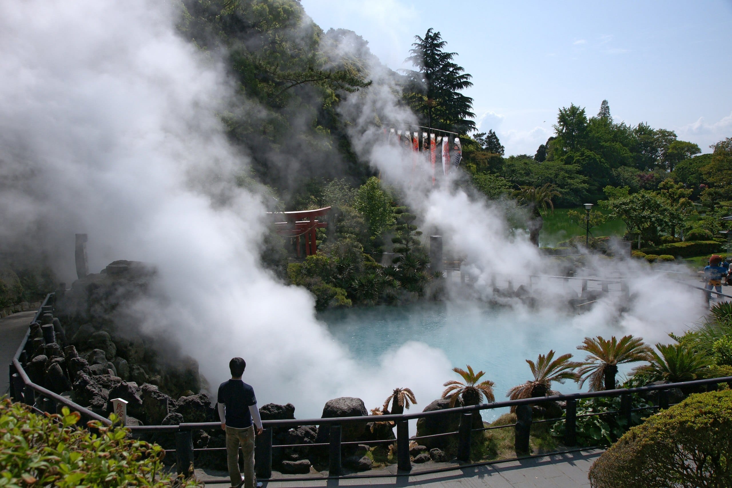 Clouds of steam rising from the cobalt-blue Umi Jigoku hot spring pond