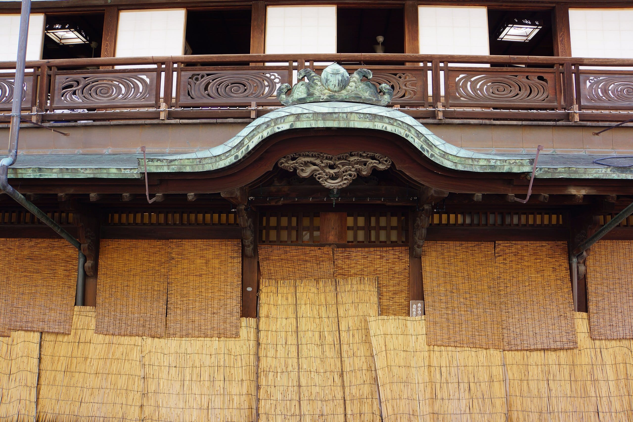 Carved wooden gable and balcony of the Dogo Onsen Honkan