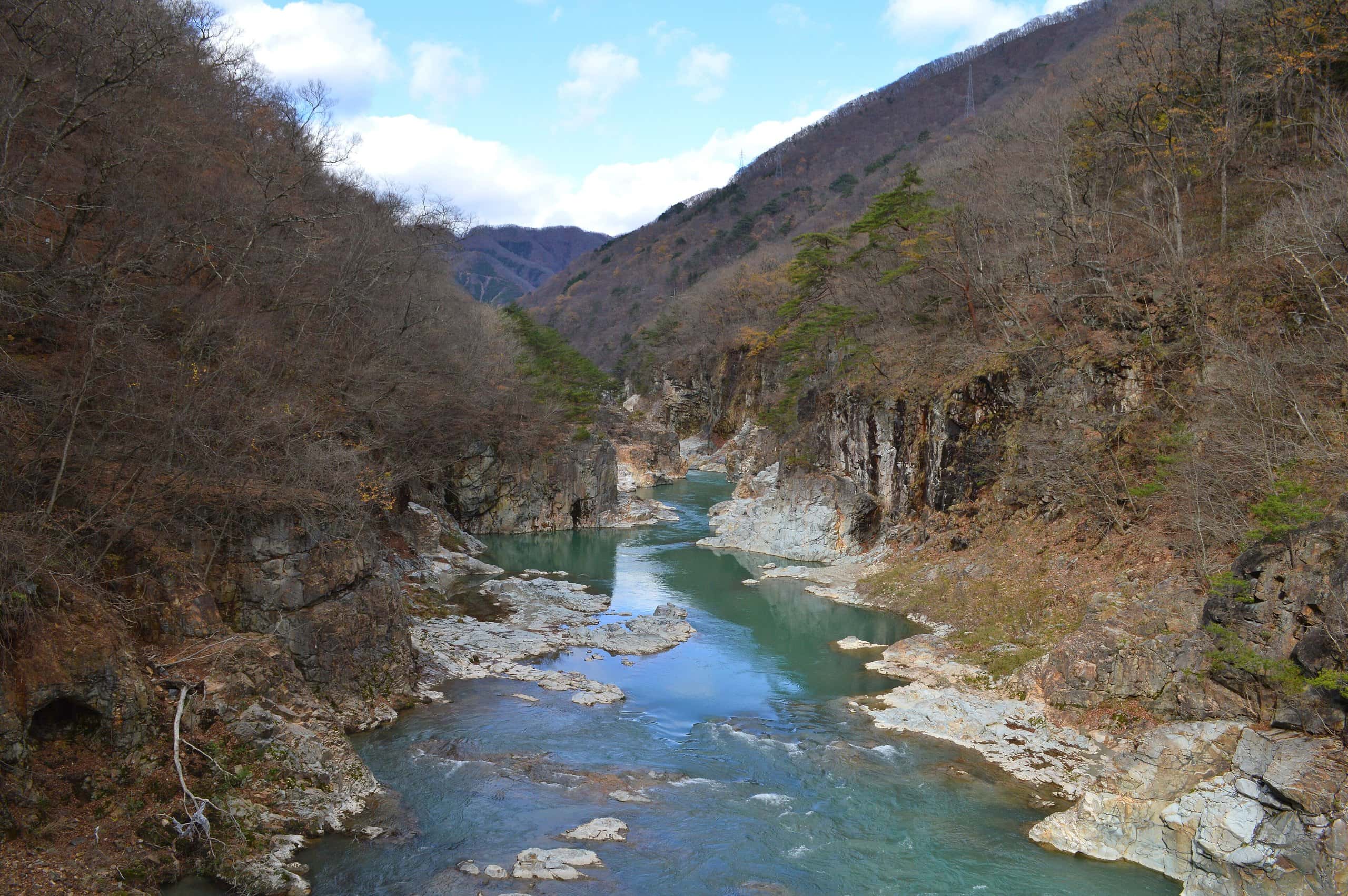 Turquoise Kinu River winding through the rocky Ryuokyo gorge in late autumn