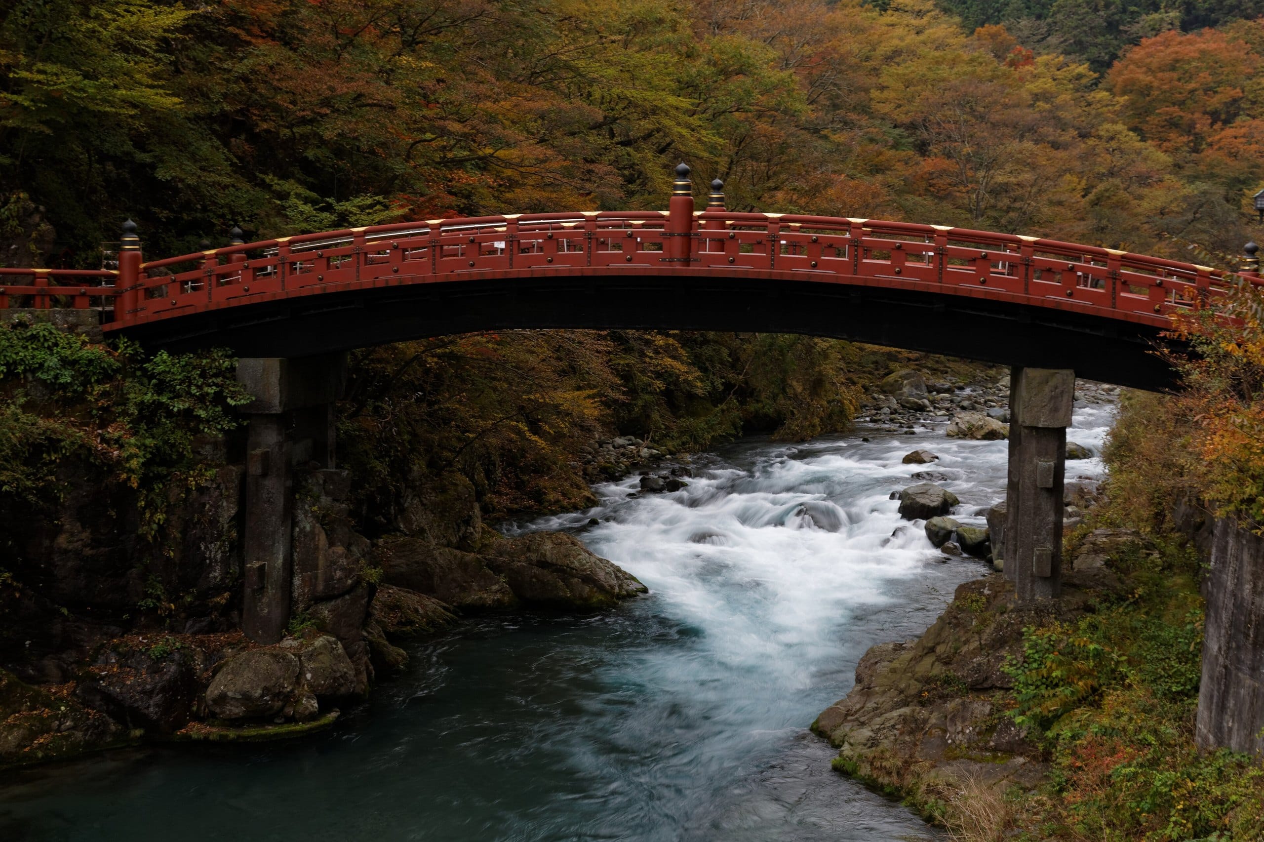Shinkyo Bridge spanning the rushing Daiya River in autumn