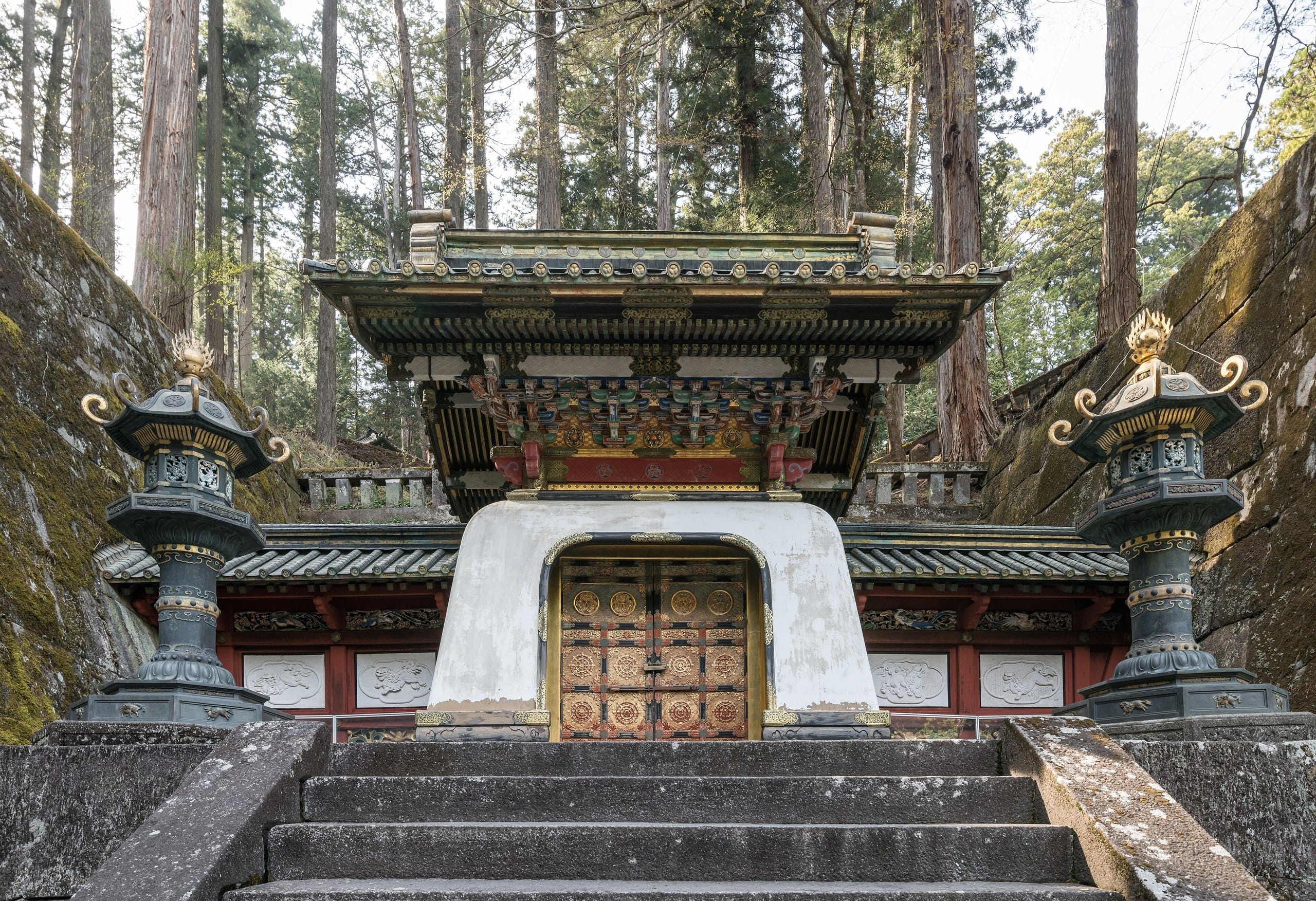Ornate Kokamon gate flanked by bronze lanterns at Taiyuin