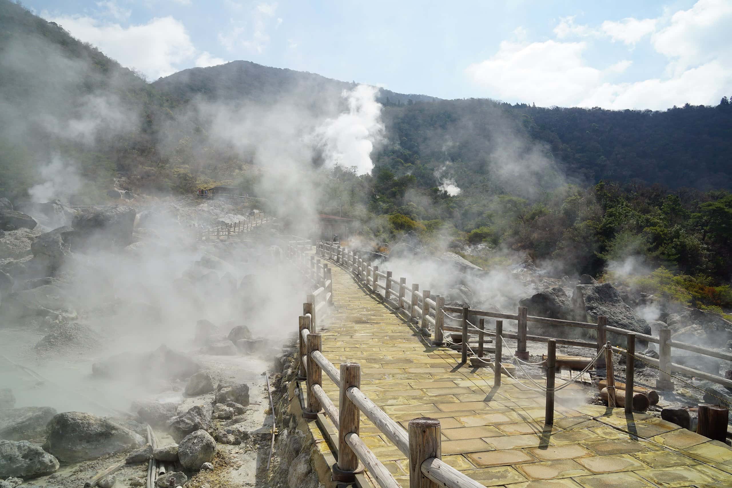 Wooden boardwalk through billowing volcanic steam at Unzen Jigoku