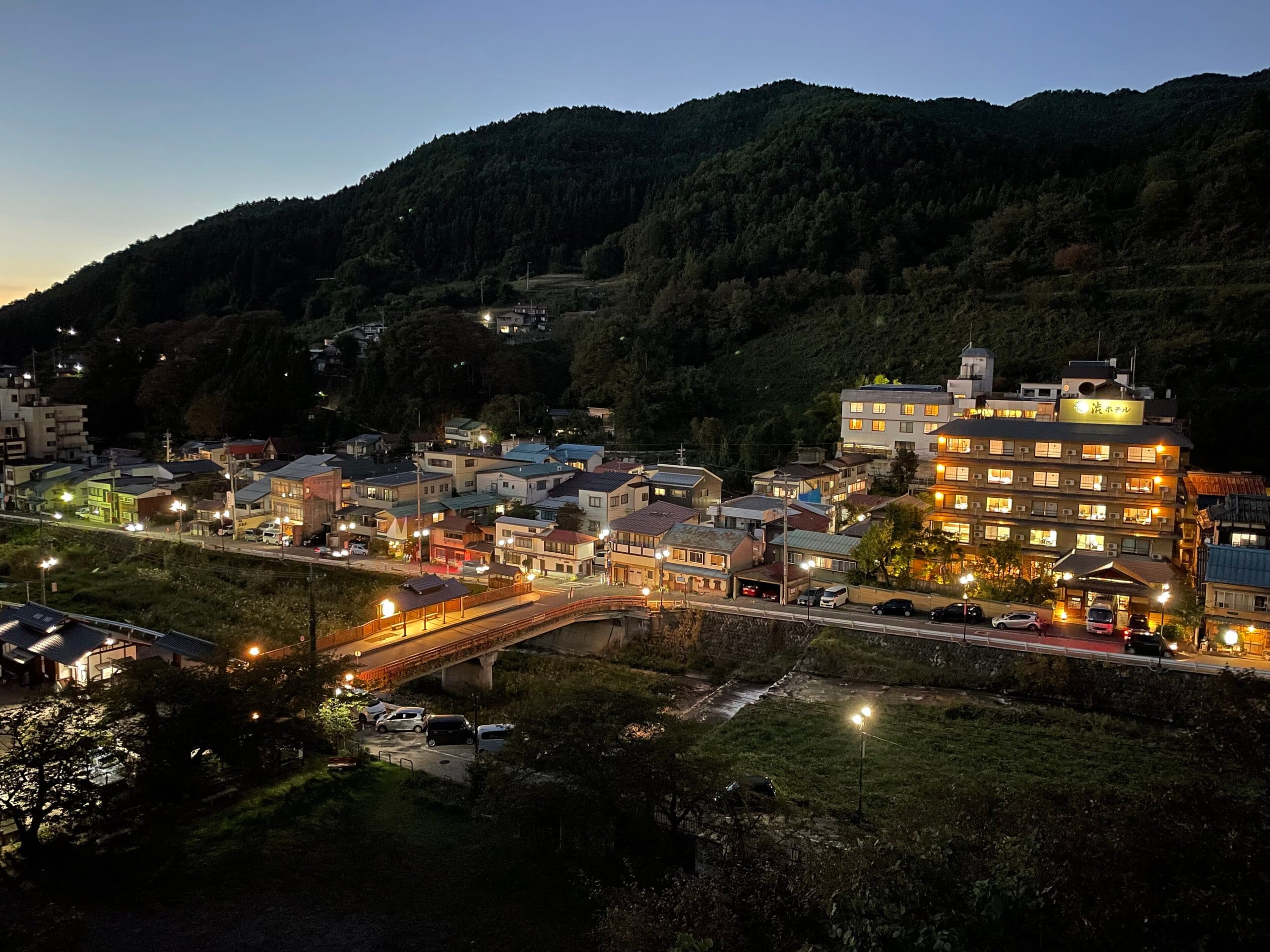 Shibu Onsen town and its river at dusk with lights coming on