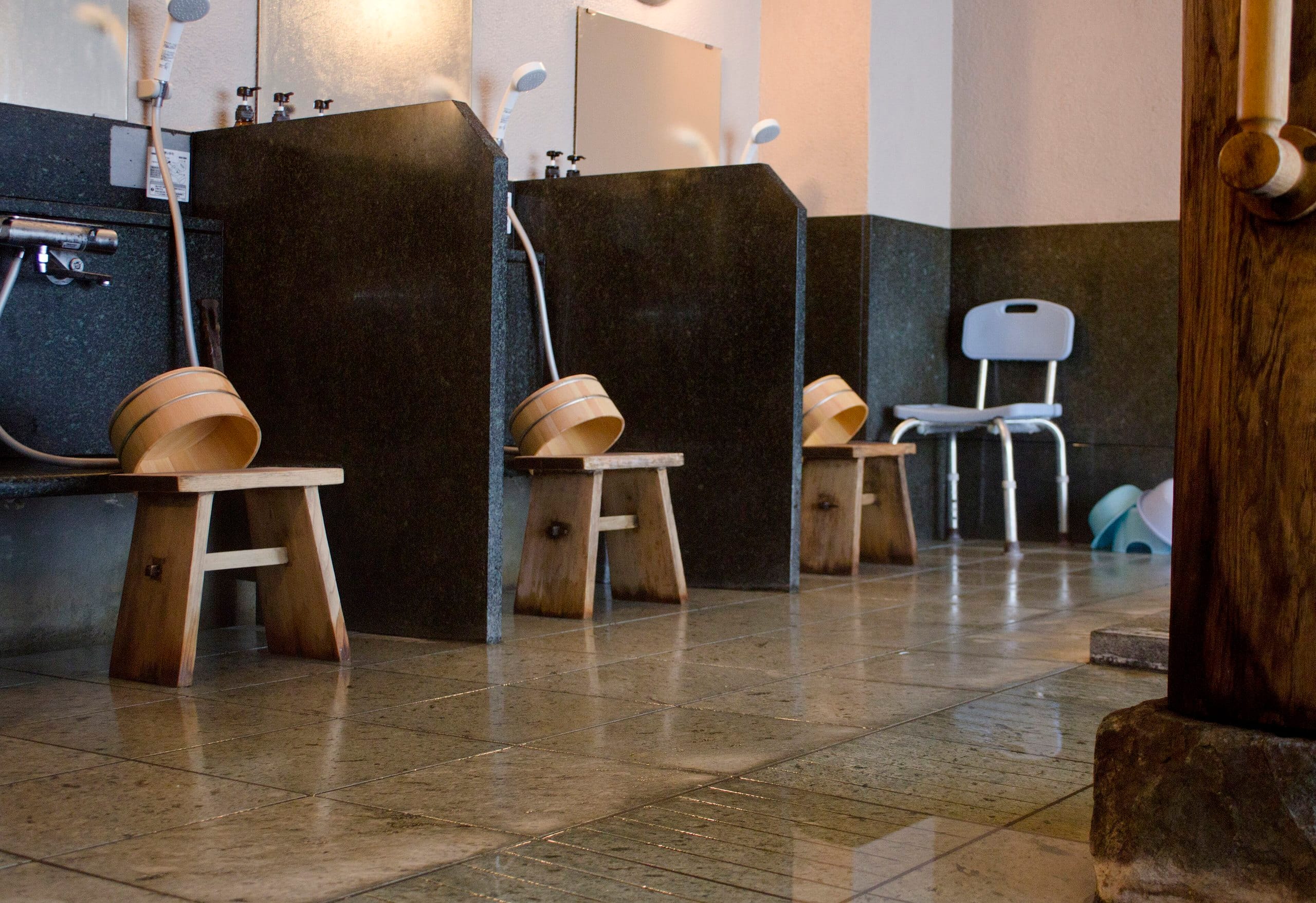 Washing stations with wooden stools and pails in a Japanese bath
