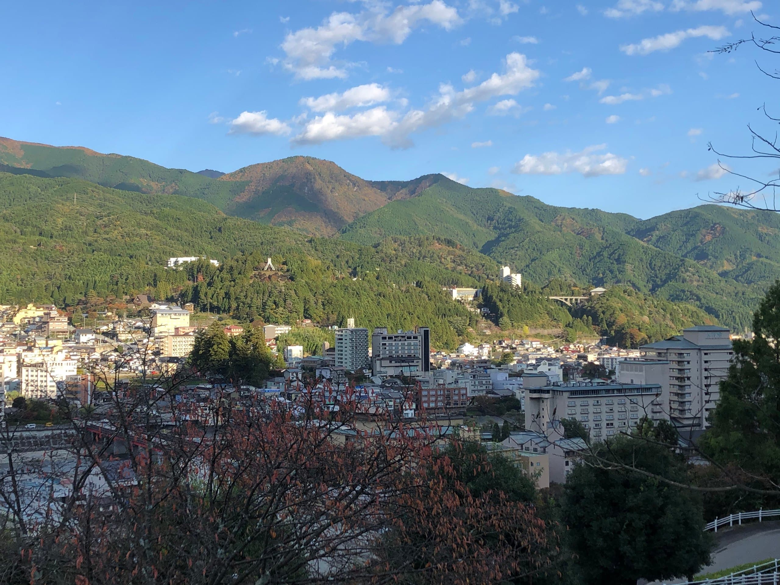 View over Gero town in its valley, with forested mountains rising behind